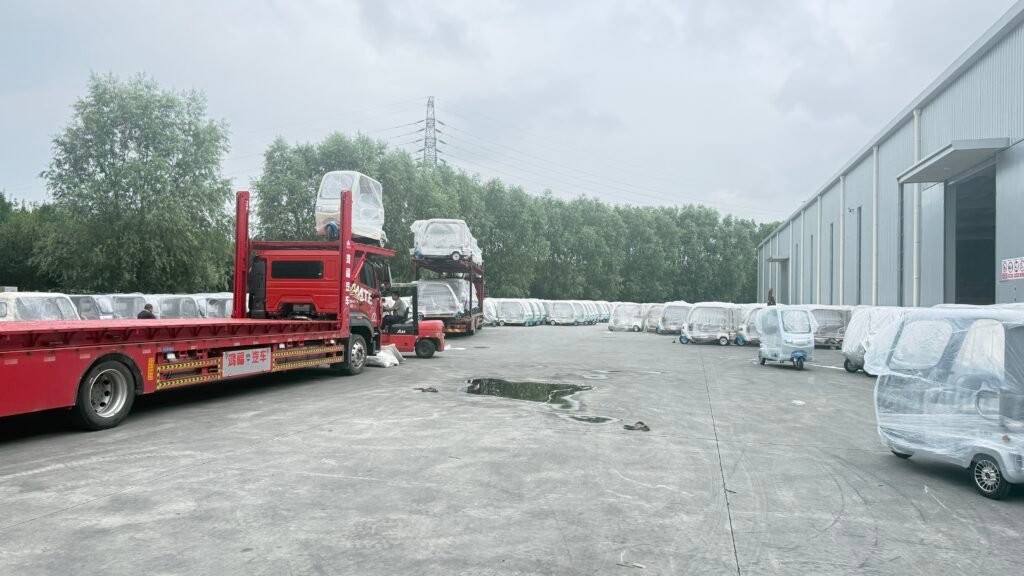 Montacargas cargando triciclos eléctricos en camión transportador para envío